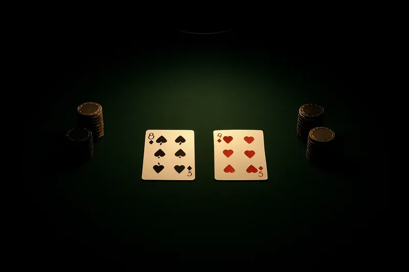 Face-up baccarat cards and chip stacks on green felt table